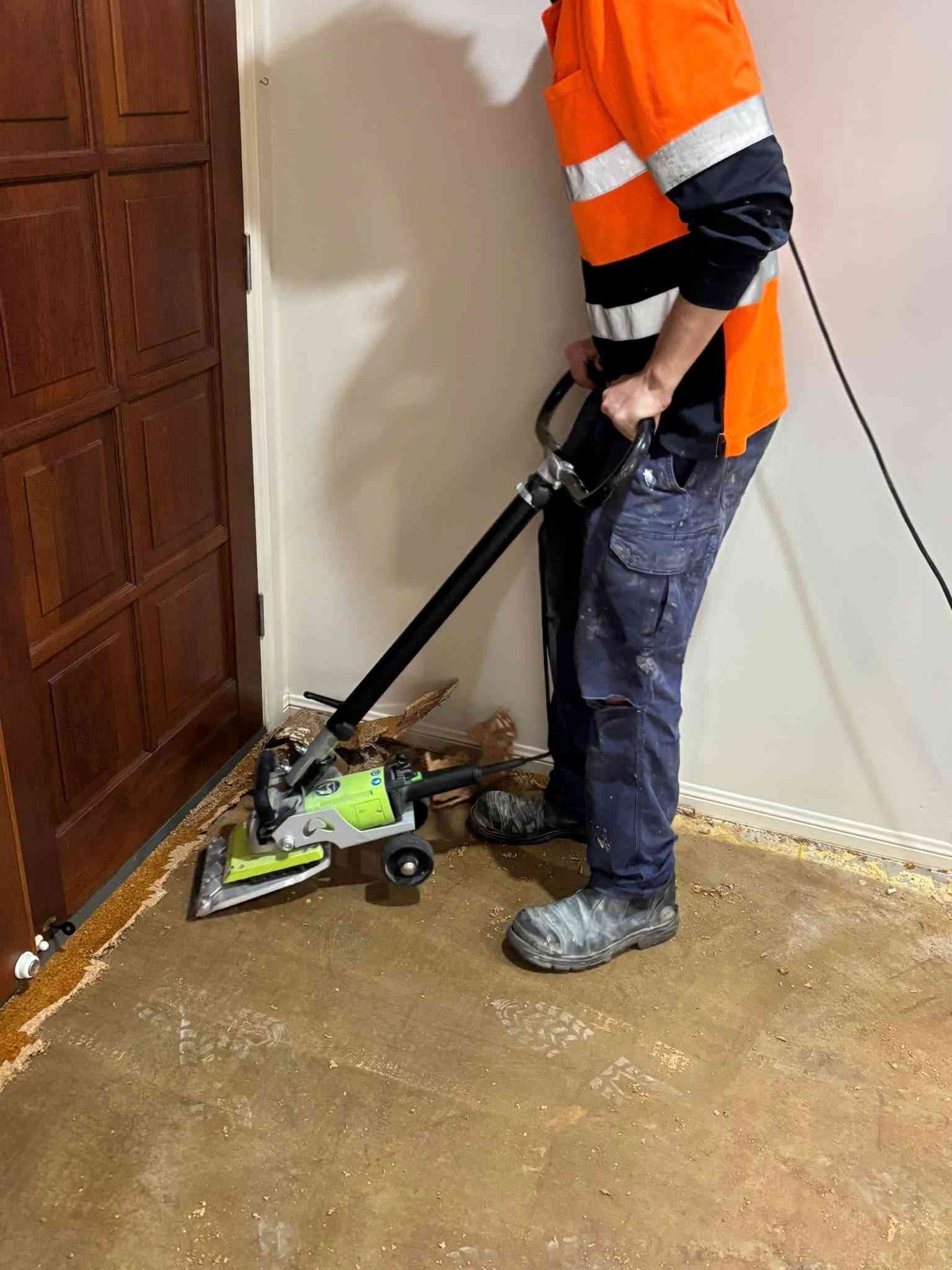 Person Using a Floor Scraper in A Room with A Door — Gava Floor Centre in Ballina, NSW