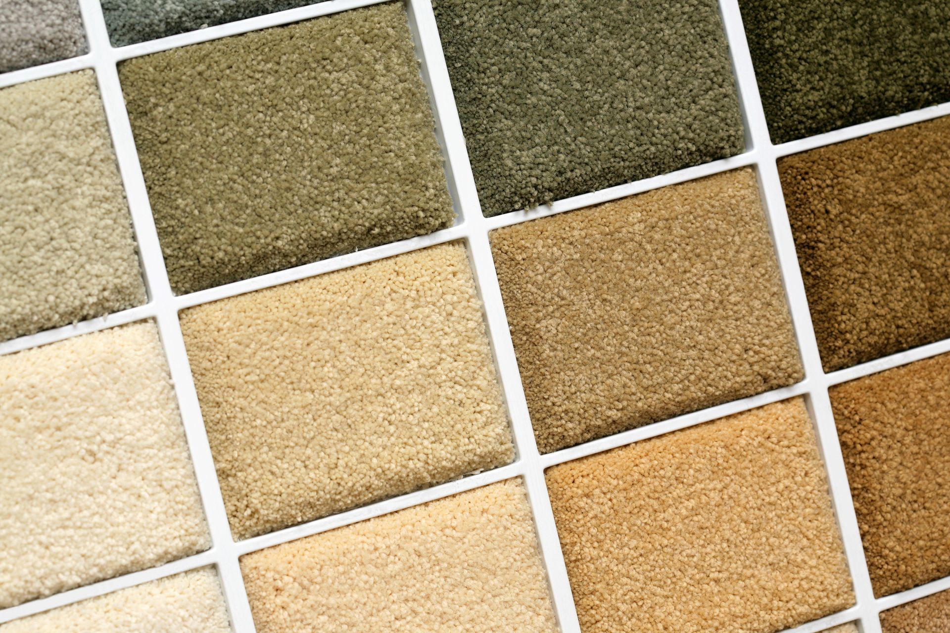 Carpet samples in various neutral shades of beige, brown, and green.
