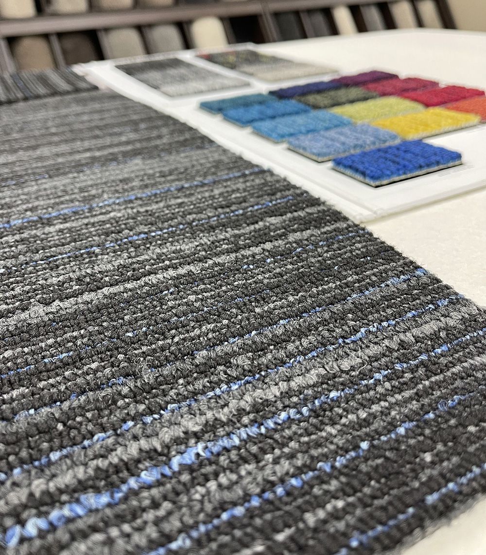 Close-Up Of A Gray Carpet Beside On A Display Rack