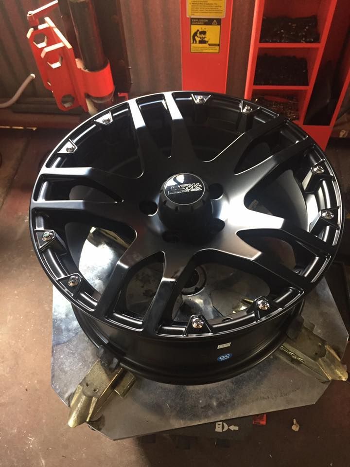 A Black Wheel Is Sitting On Top Of A Tire Changer — Cannon Automotive Services In East Maitland, NSW