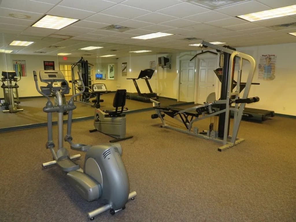 Lions Court Apartments Fitness Center with multi-station exercise equipment and stationary bike | Wichita Falls, Texas