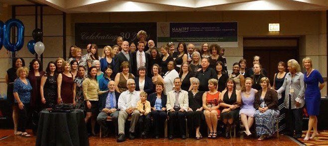 A large group of people are posing for a picture at a party