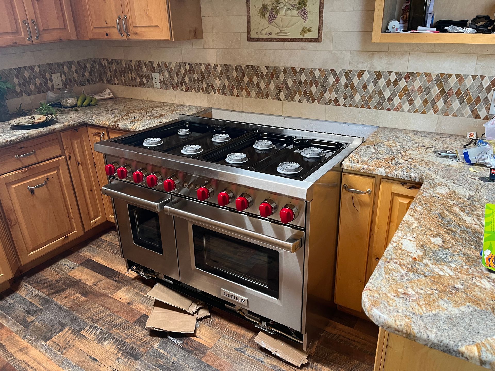 A kitchen with a large stove top oven and a microwave.