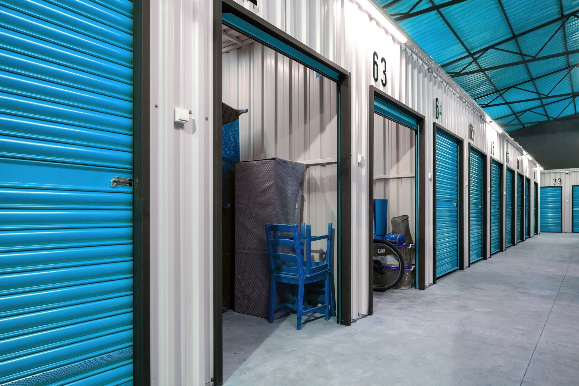 A row of storage units with blue doors.