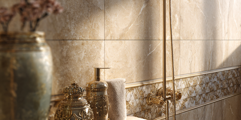 Bathroom interior with ornate gold fixtures and beige tile. Soft lighting highlights details.