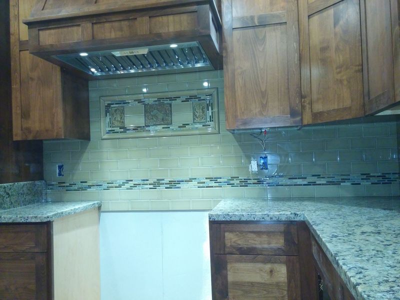Kitchen with wooden cabinets, granite countertops, and tiled backsplash.