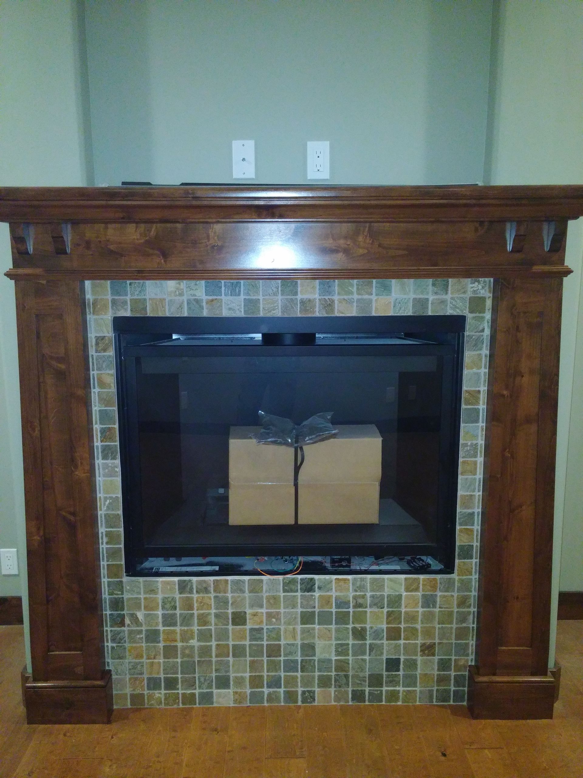 Fireplace with wood mantel and tiled surround, box inside.