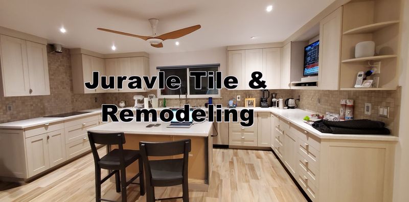 A renovated kitchen with light cabinets and tile backsplash, an island, and wood floors. Text 