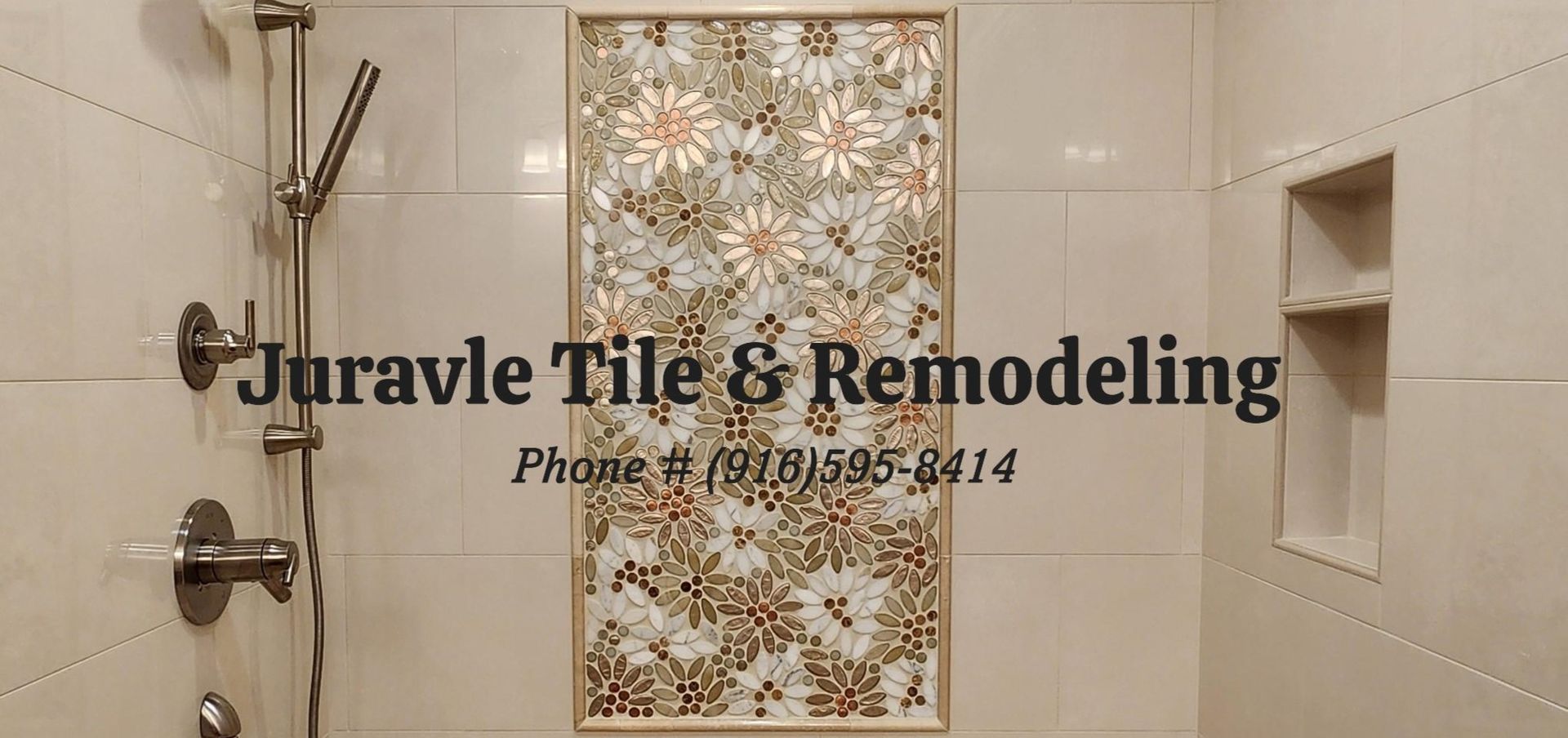 Shower remodel with floral tile insert, shower head, and built-in shelf. Beige and silver tones.