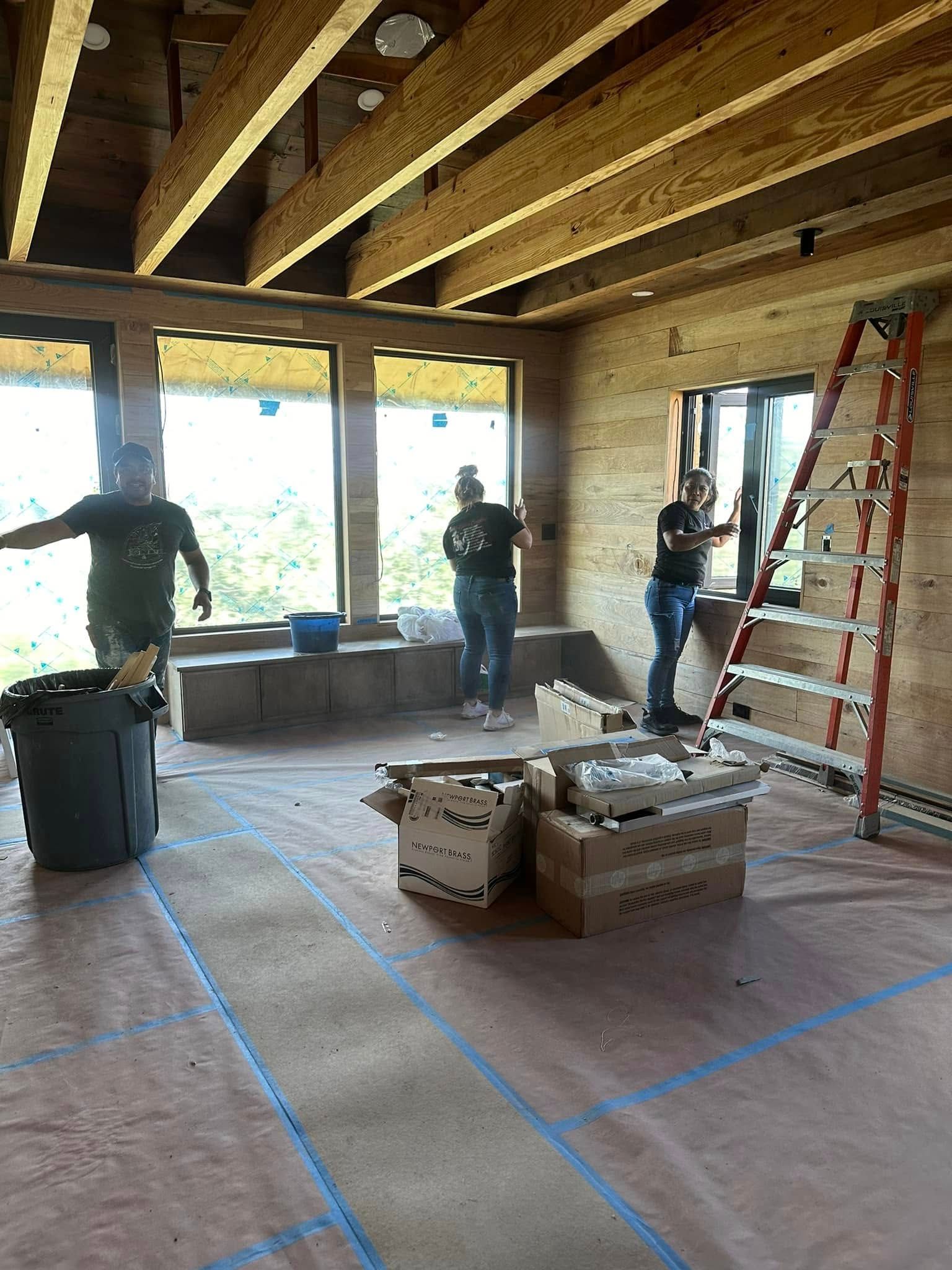 A group of people are working on a house under construction.