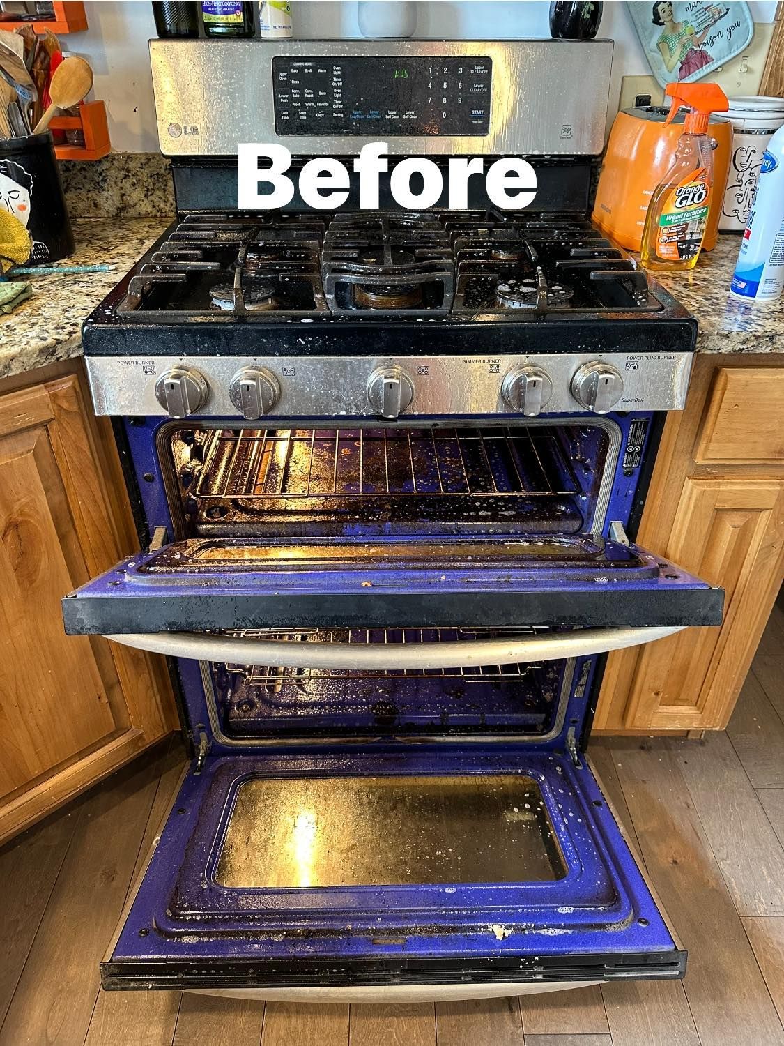 A dirty stove with the door open in a kitchen.