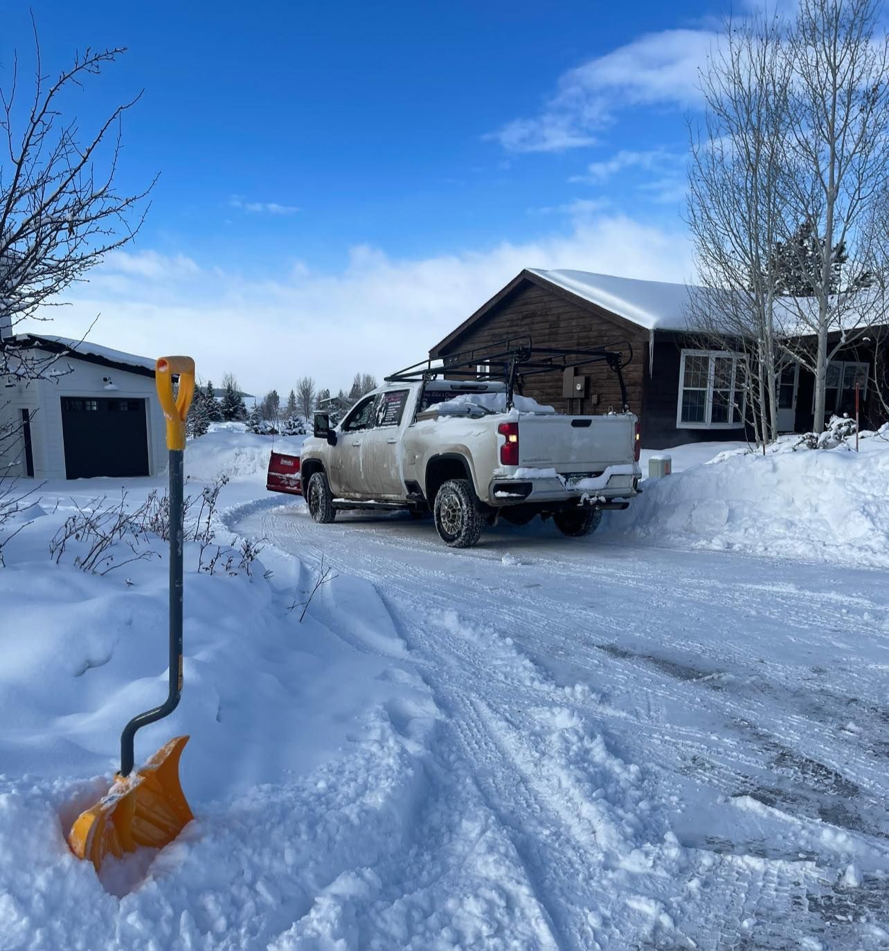 A group of people are clearing snow from a hot tub.