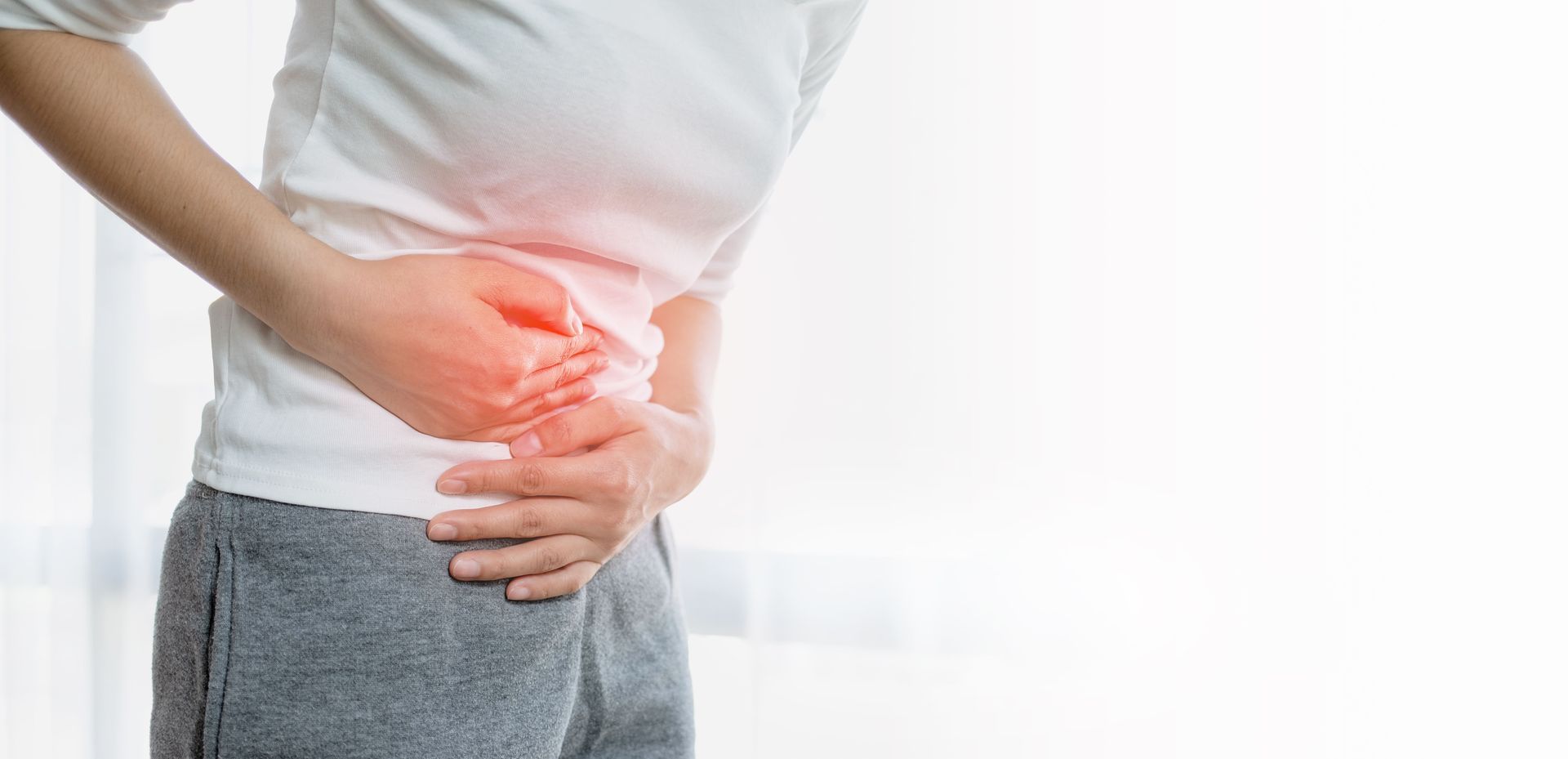 A man is holding his stomach in pain.