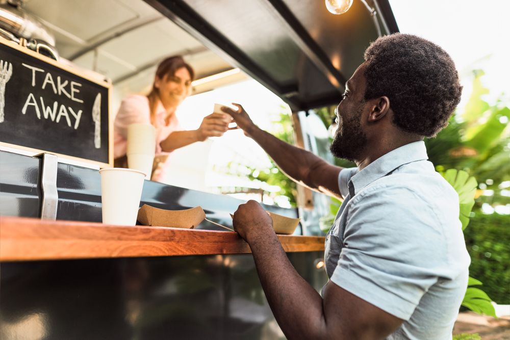Man Buying Coffee From Food Truck — Evansville, IN — Kingdom Grounds Coffee Man Buying Coffee From Food Truck — Evansville, IN — Kingdom Grounds Coffee
