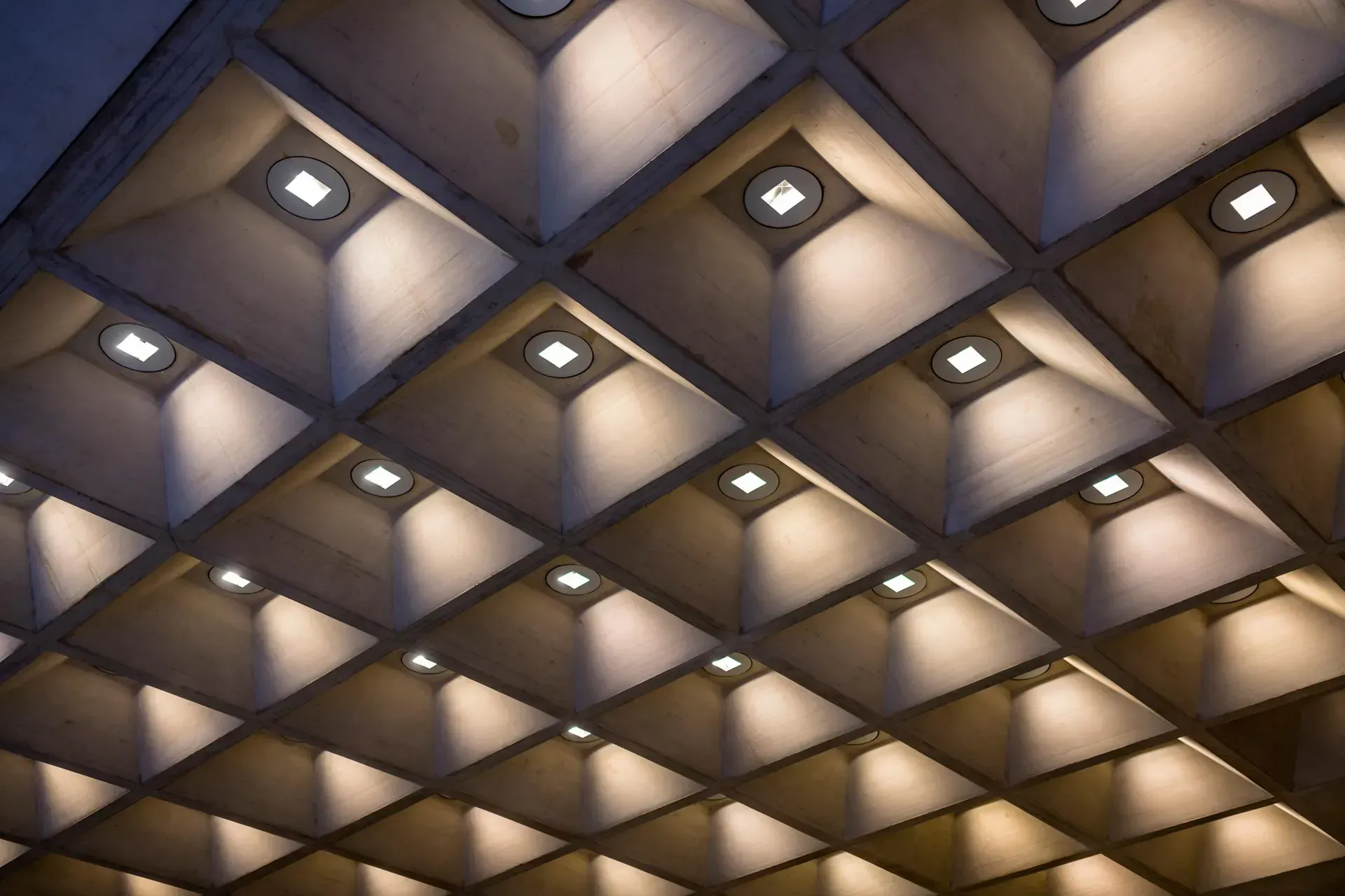 Geometric ceiling with diamond-shaped recessed lights in warm and cool tones