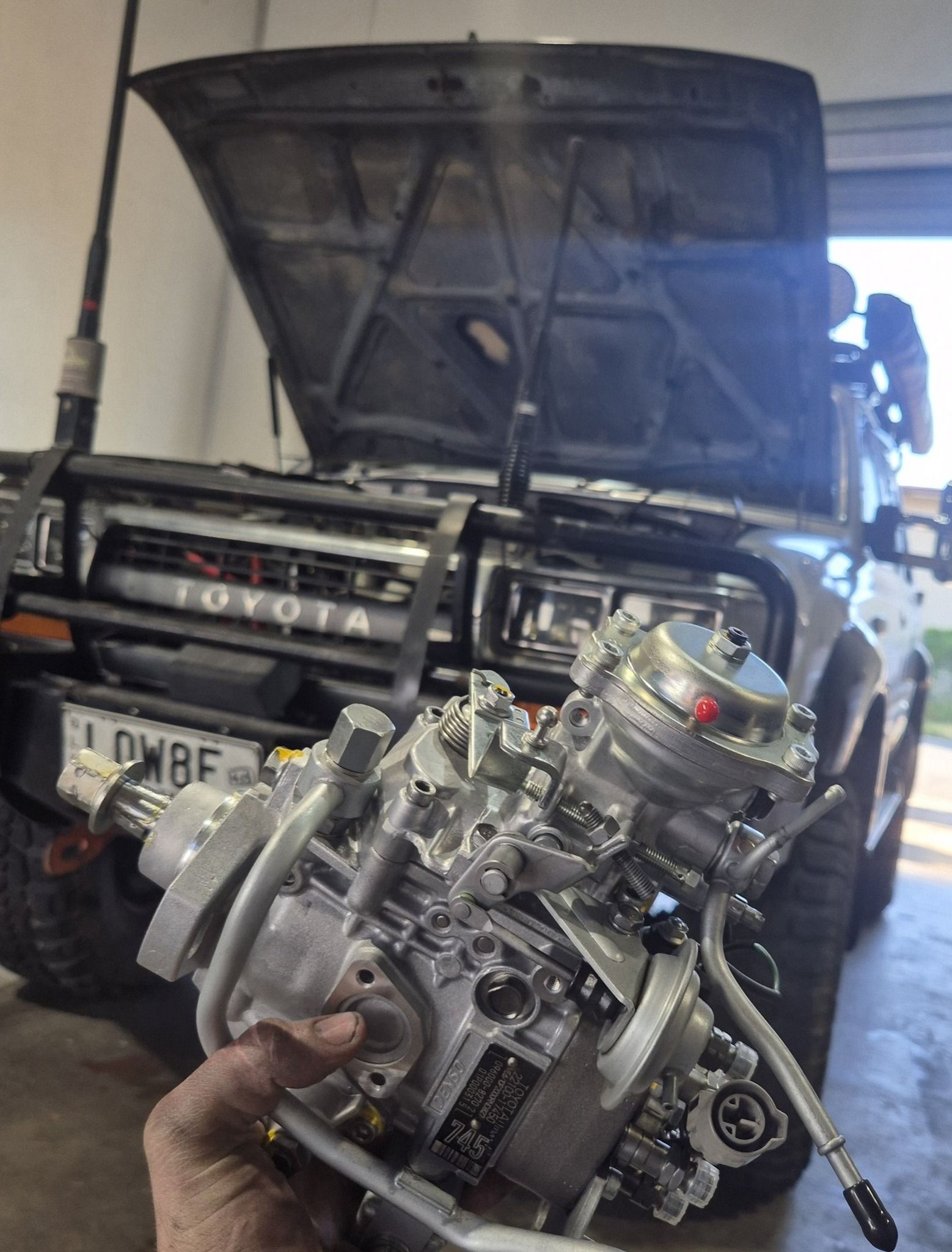 A Close-up of a Mechanic Holding a Refurbished Diesel — Dynamic 4X4 Off Road Performance & Mechanical in Garbutt, QLD