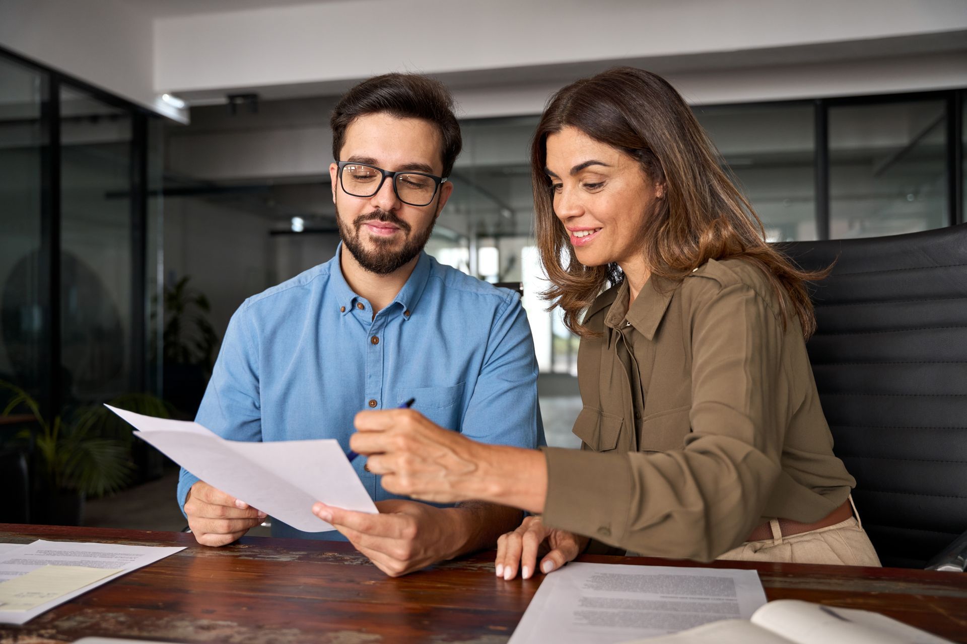 Man and woman in an office reviewing documents