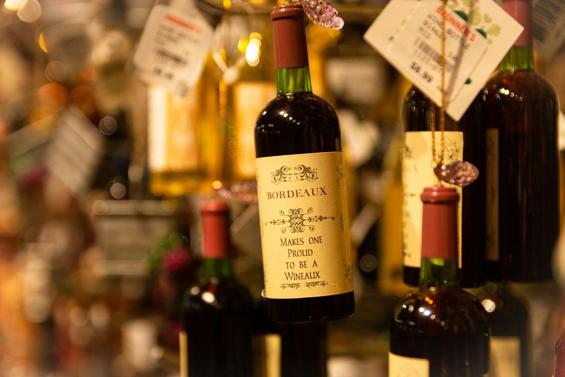 Wine bottles on display, with a focus on a Bordeaux bottle with a cream-colored label.