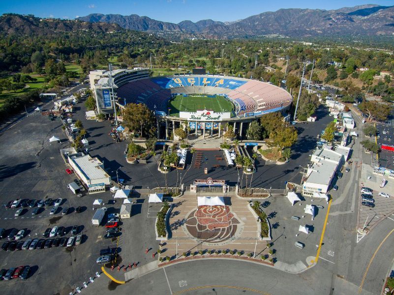 An aerial view of a stadium with mountains in the background
