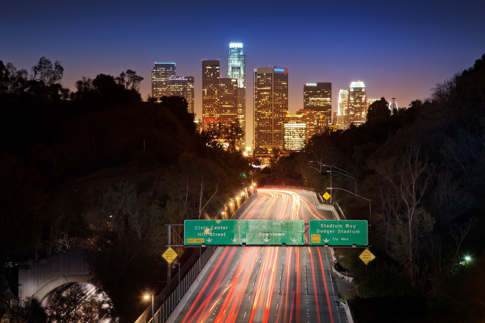 A highway at night with a city in the background