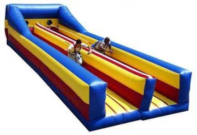 Two people are playing a game on an inflatable track