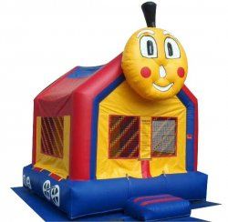 A yellow and red bouncy house with a train face on it.