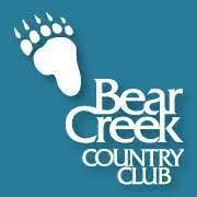 A bear creek country club logo with a footprint on a blue background.
