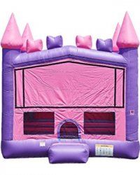 A pink and purple bouncy house in the shape of a castle.