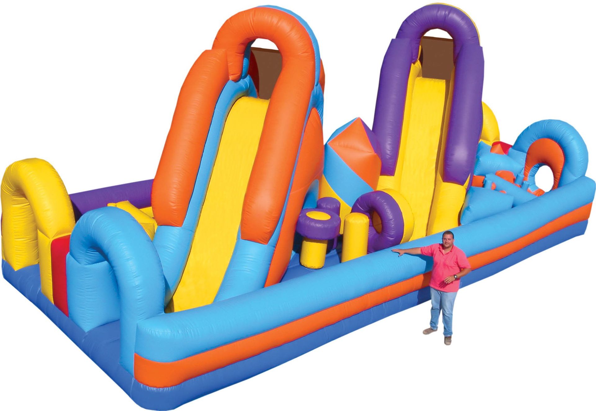 A man is standing next to a large inflatable obstacle course