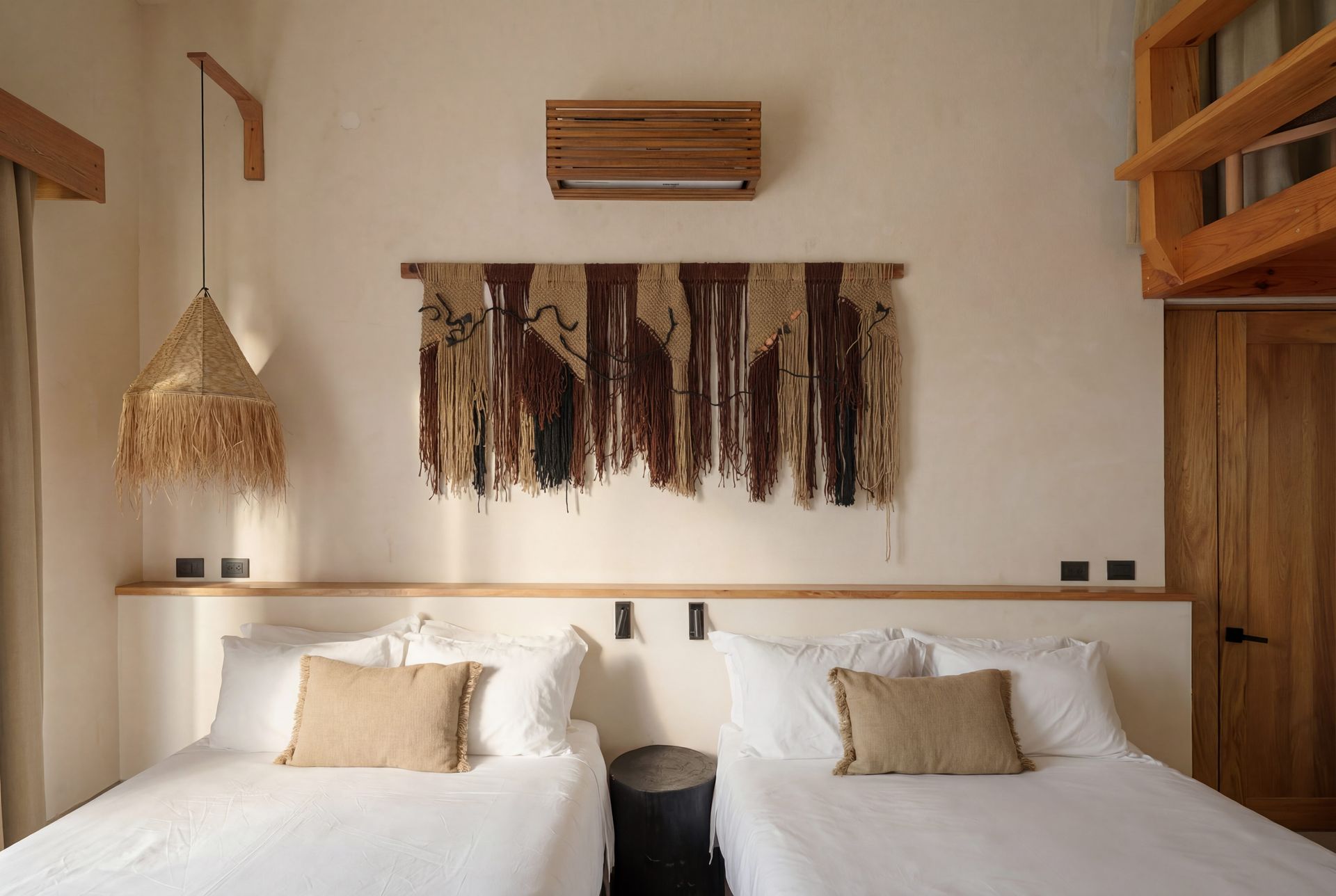 Cozy bedroom with two twin beds, woven wall decor, and warm wood accents