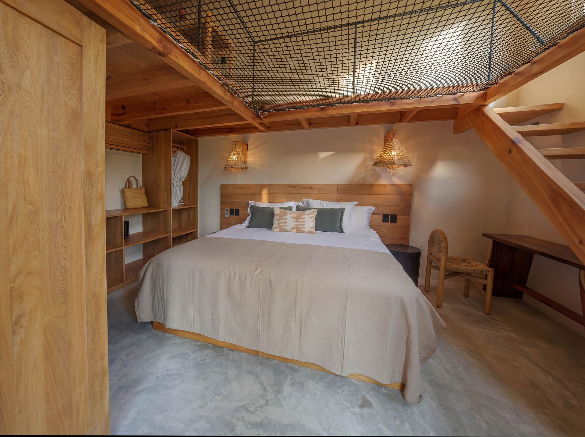 Cozy rustic bedroom with a wooden bed, woven ceiling decor, and slanted loft-style walls