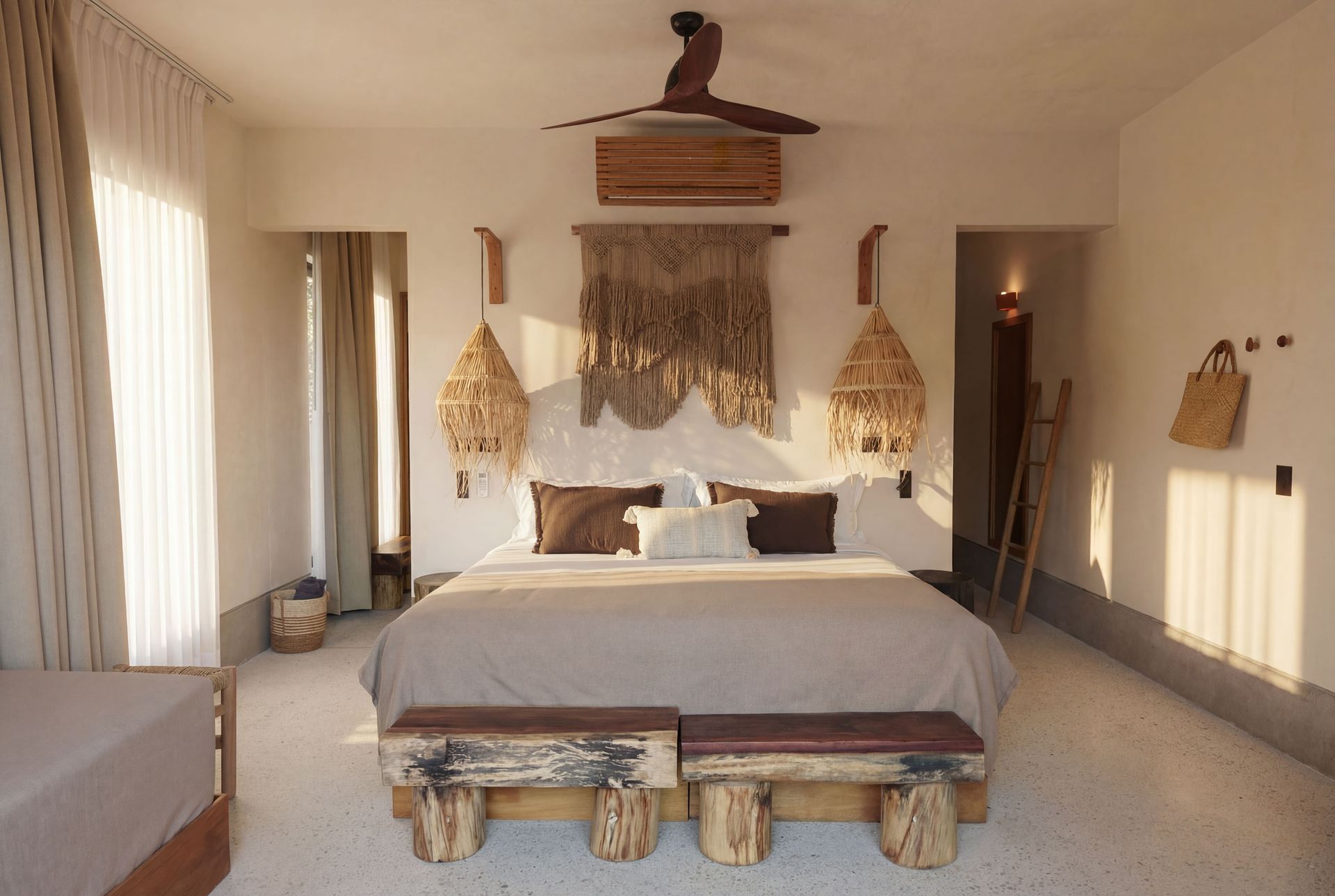 Cozy neutral-toned bedroom with a large bed, woven pendant lights, and rustic benches at the foot.