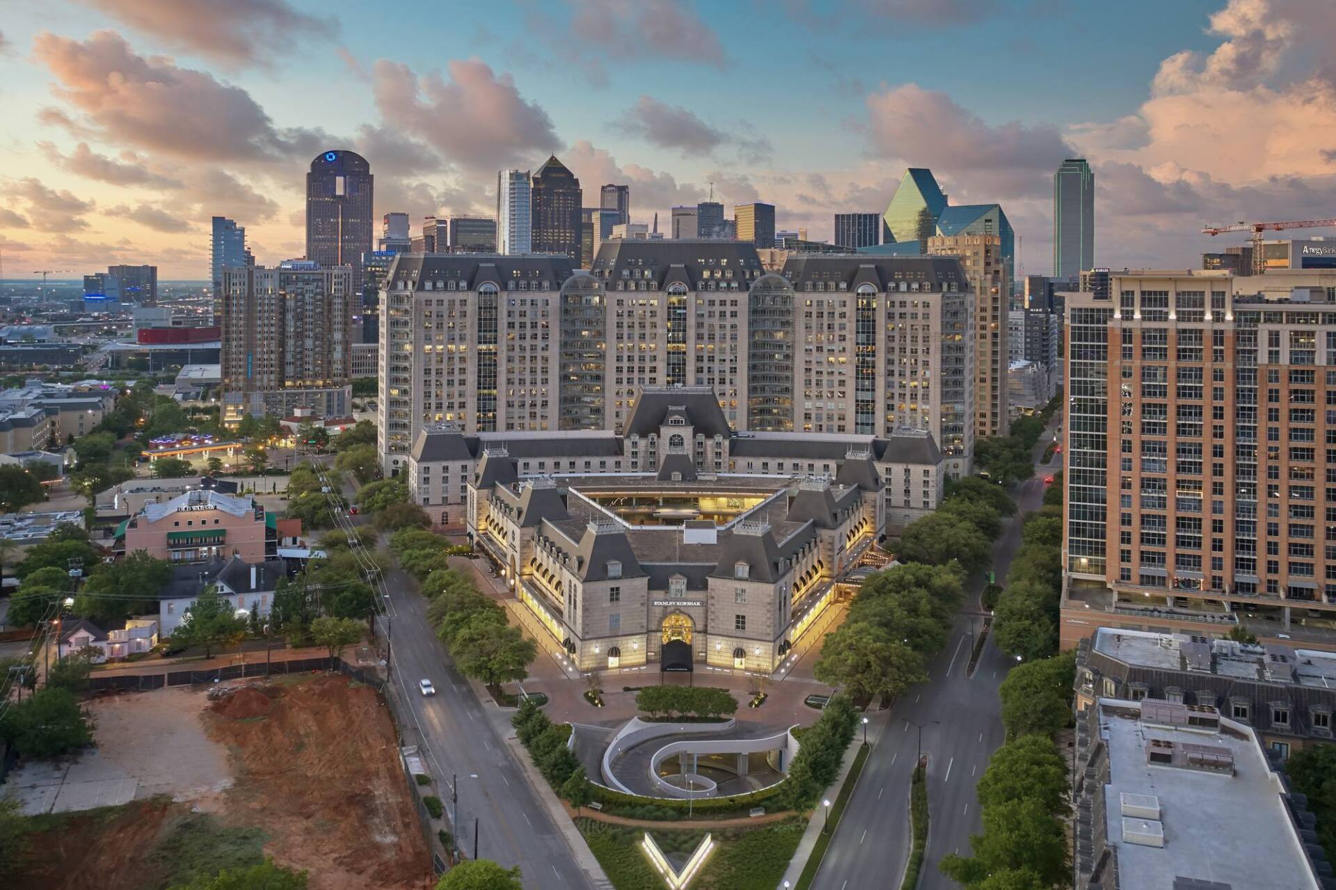 Aerial view of a Dallas cityscape with a large, ornate building in the foreground and skyscrapers.