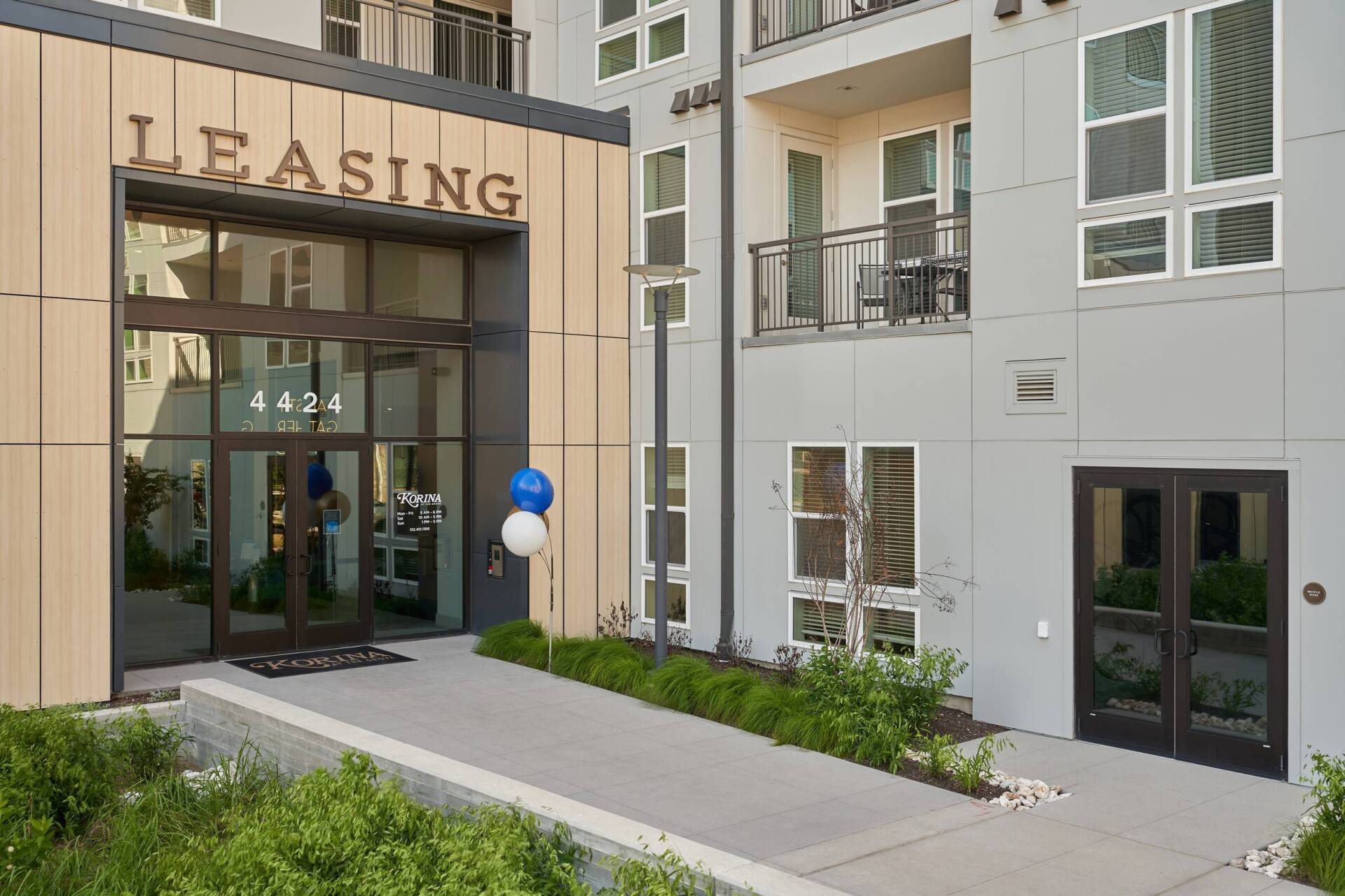 Entrance to a leasing office with glass doors, the word 