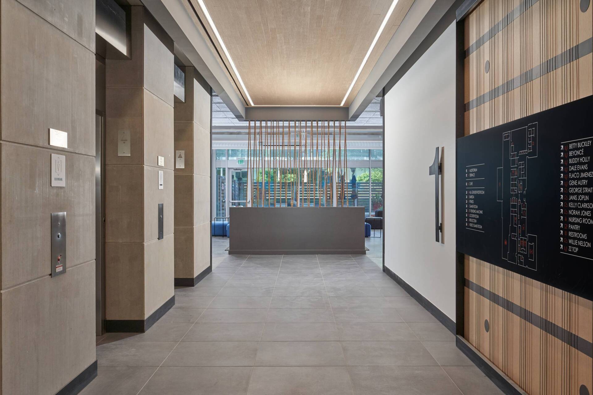 Elevator lobby with light-colored tile floors and walls.