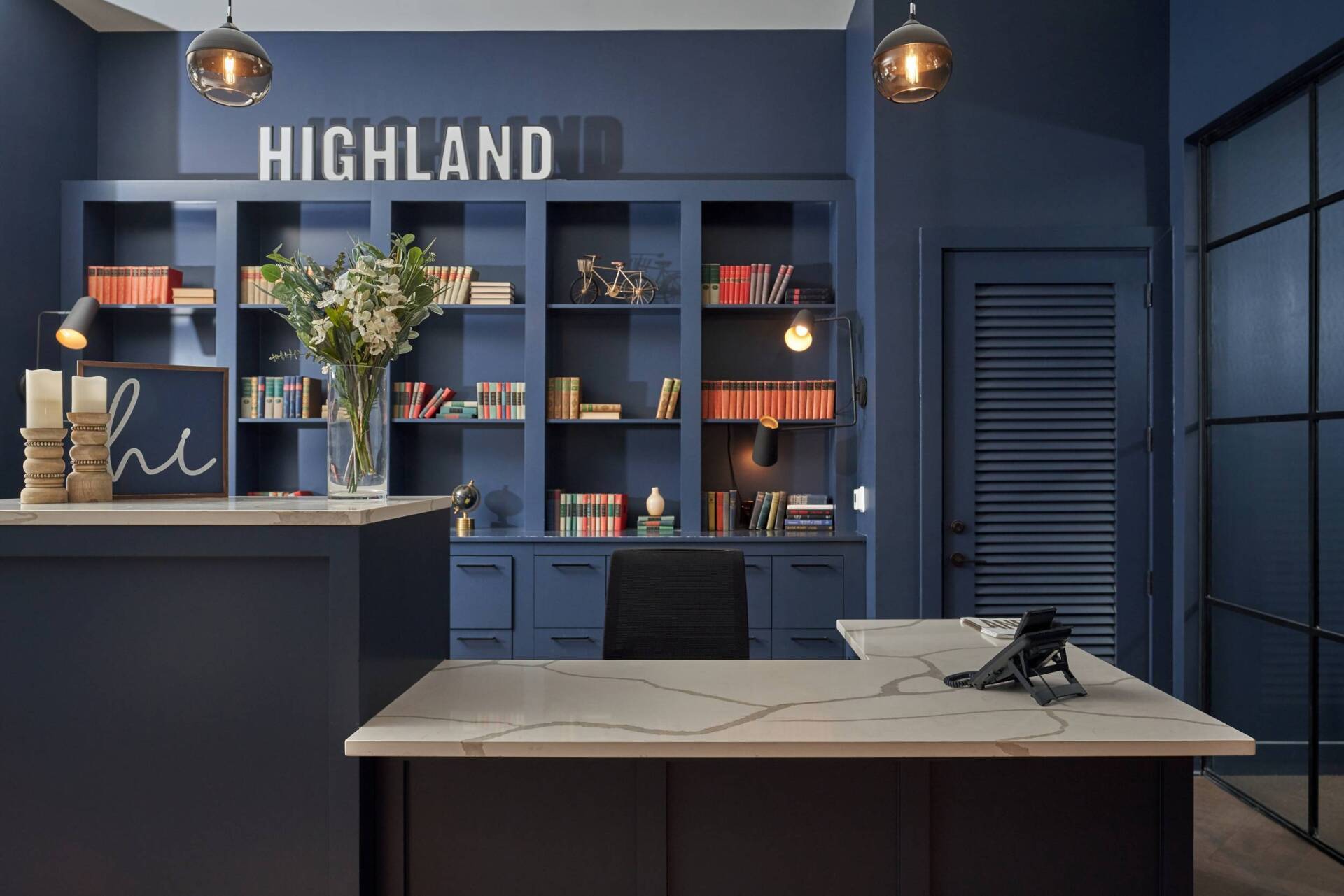 Blue office space with built-in bookshelves,