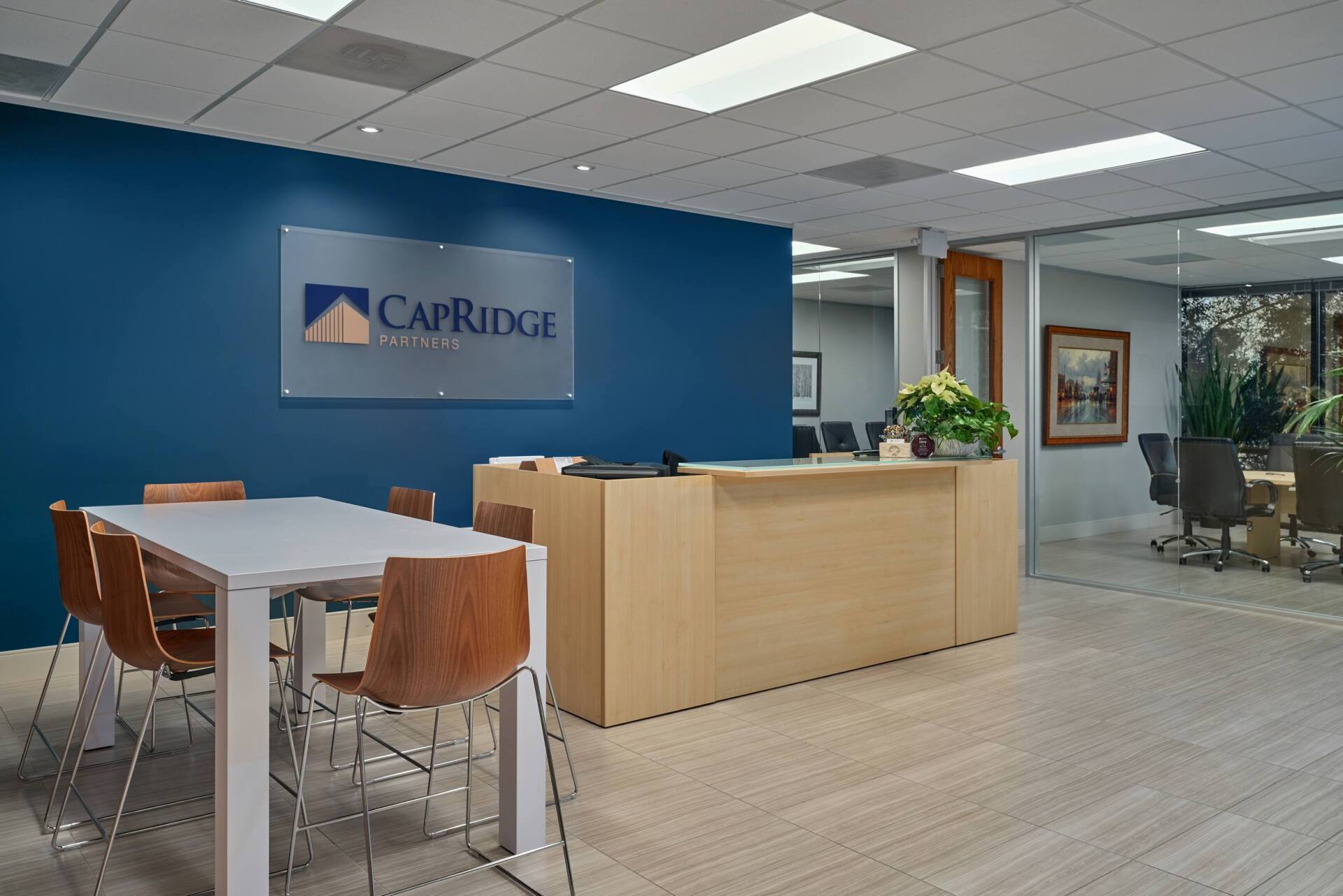 Cambridge Law office entrance with reception desk, meeting table, and blue accent wall.
