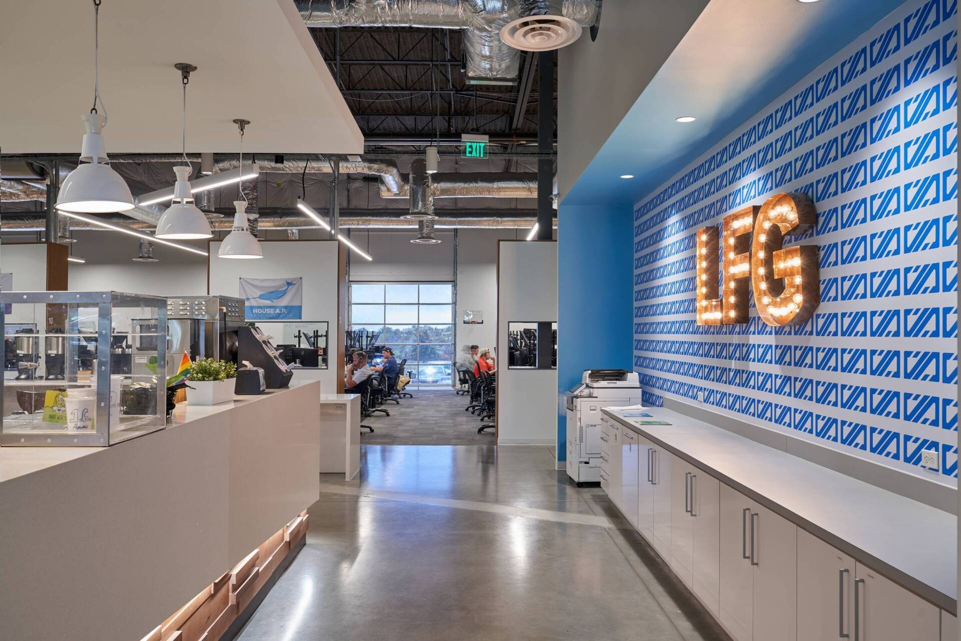 Modern office interior with white reception desk, blue accent wall with