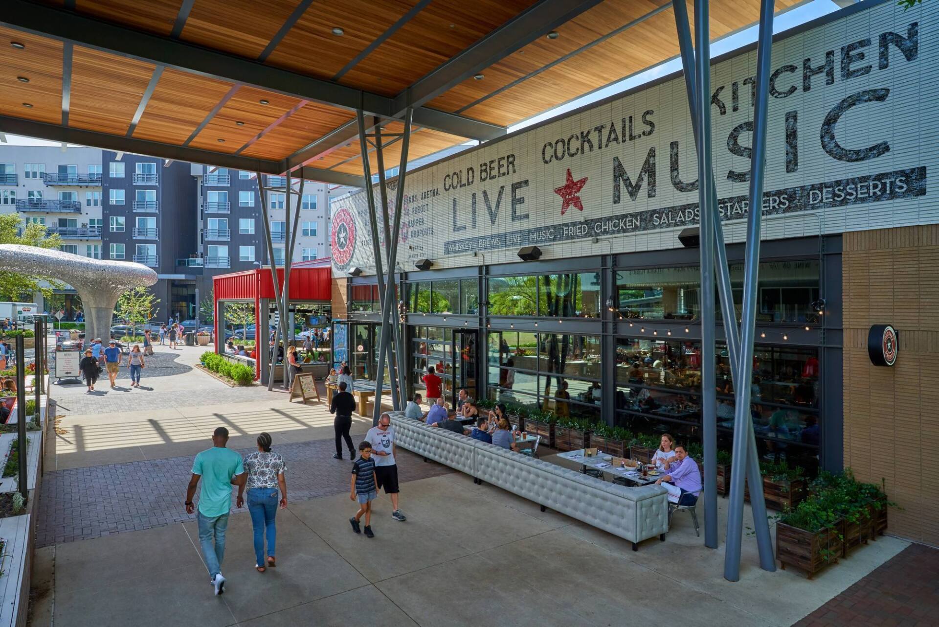 Restaurant entrance with seating, signage 