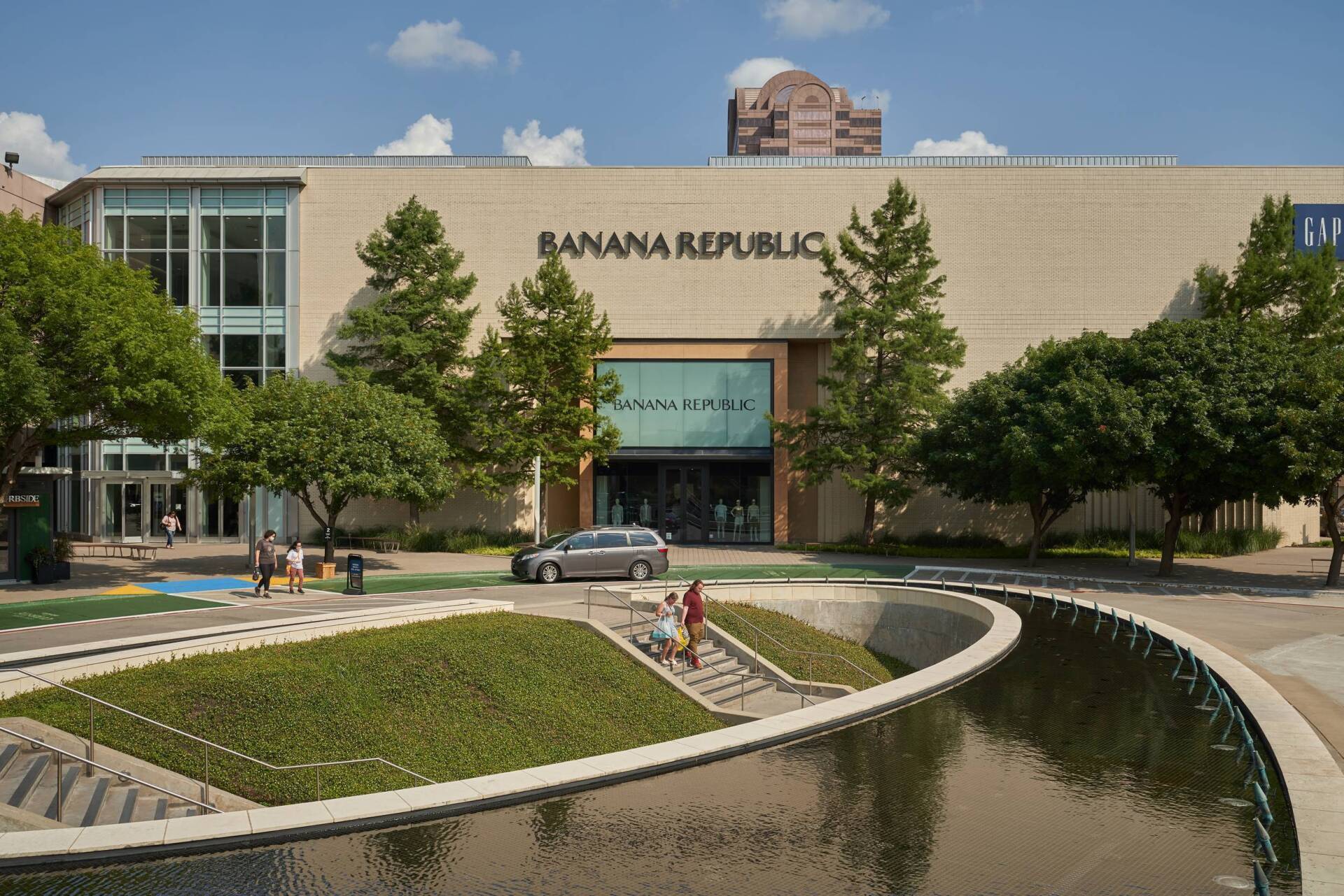 Banana Republic store exterior with landscaping and water feature.