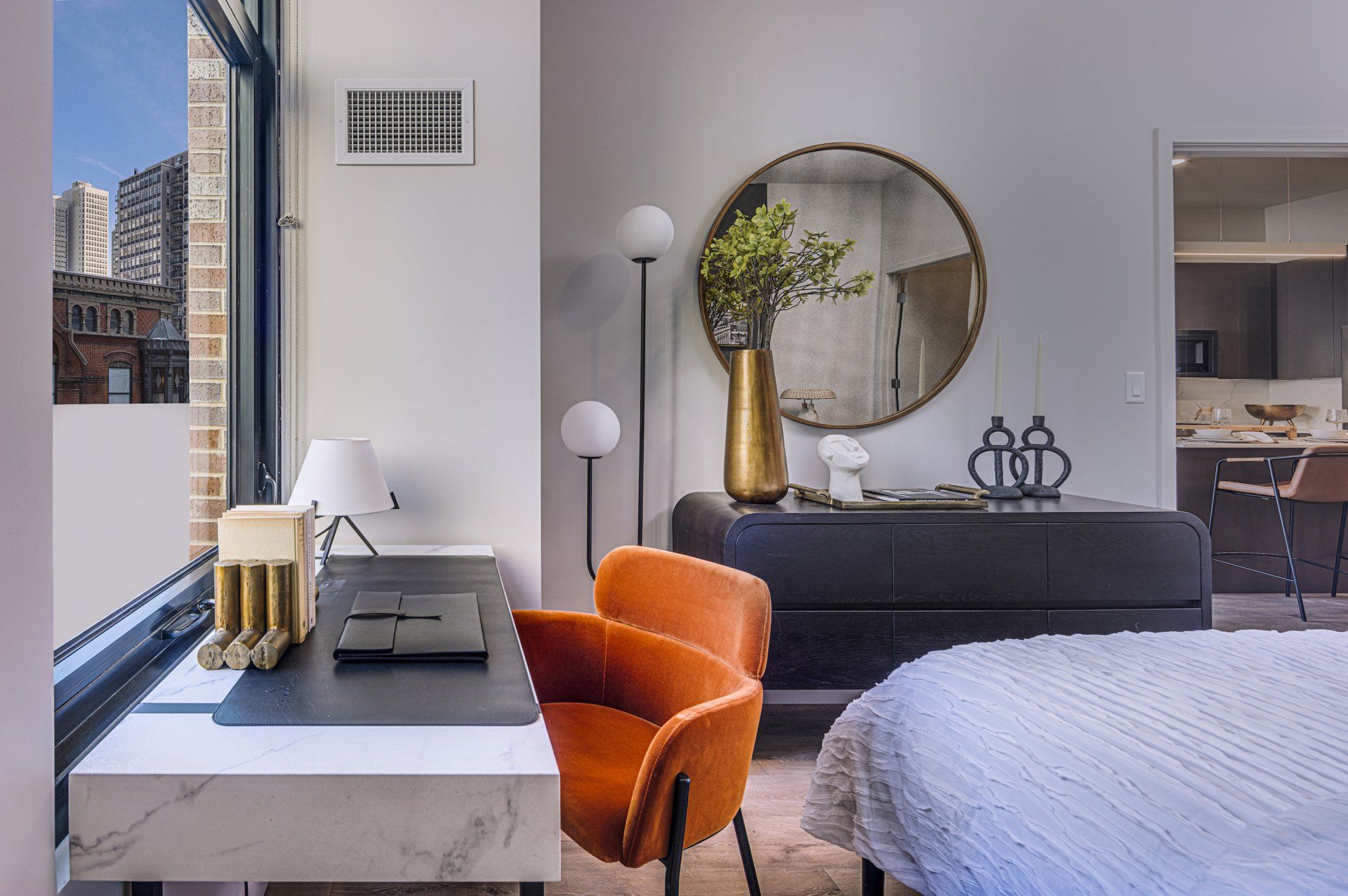 Modern apartment bedroom with work space at Gild Apartment.