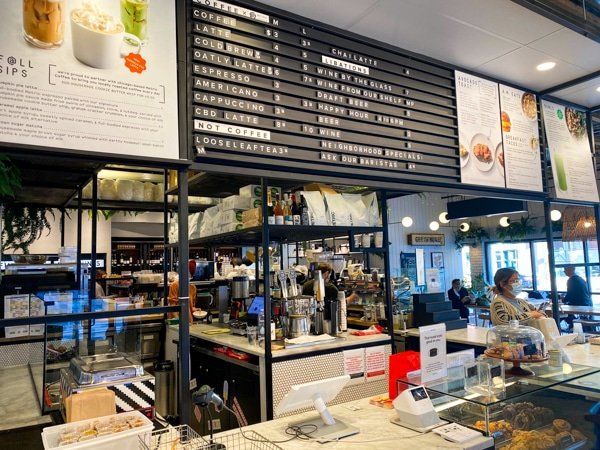 A woman is sitting at a counter in a restaurant.
