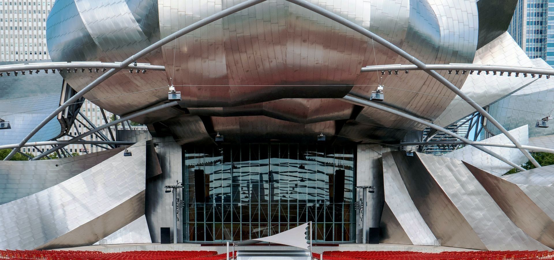 The front of a large building with a fence in front of it.