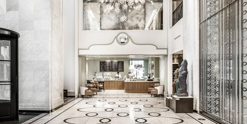 A large lobby with a statue of a lion in the middle.