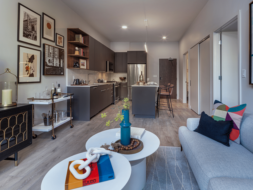 Open floor plan with living room oversees the kitchen at Gild Apartment.
