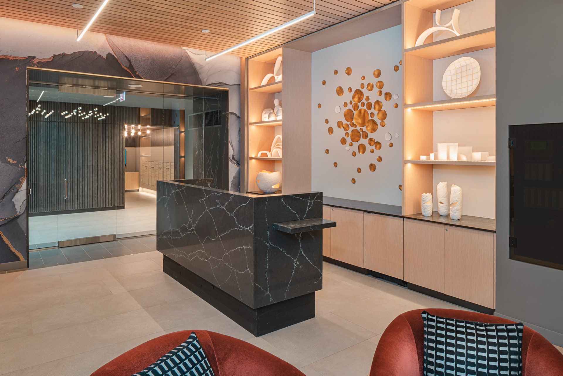 Front desk of the apartment building with black marble desk at Gild Apartment.