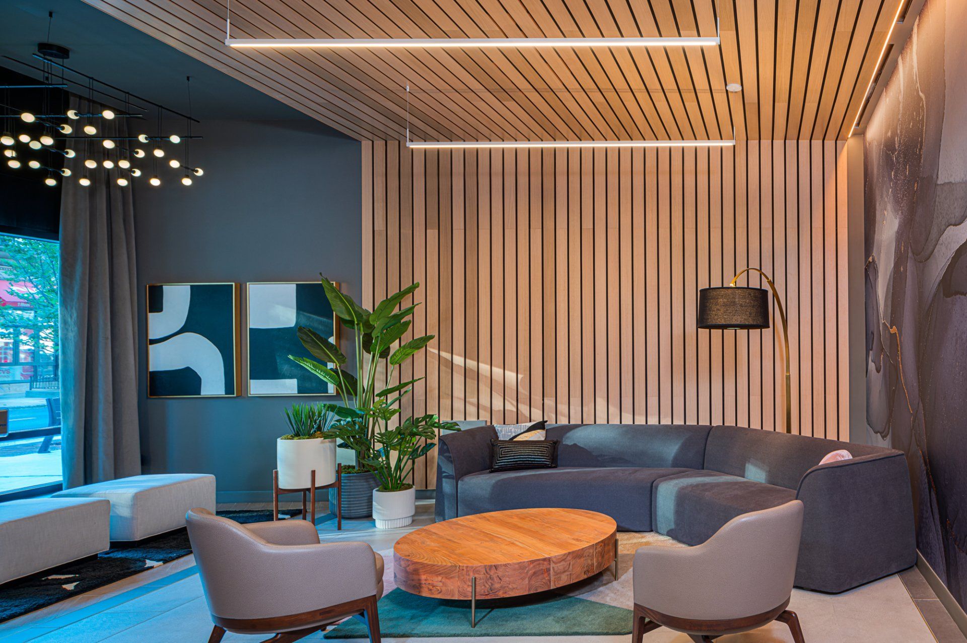 Luxury apartment community resident lounge with designer lighting and sofa at Gild Apartment.