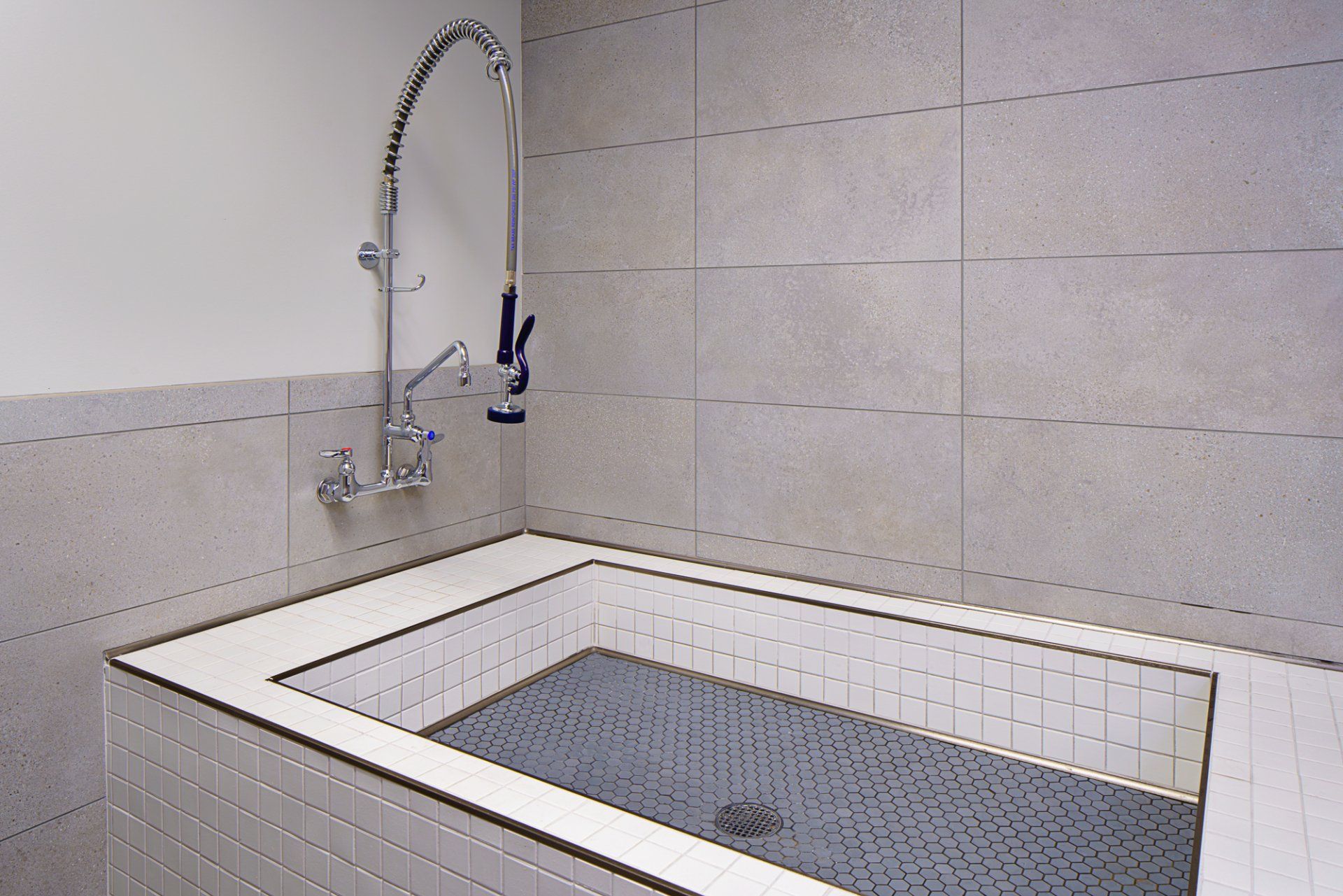 A bathroom with a bathtub and a faucet