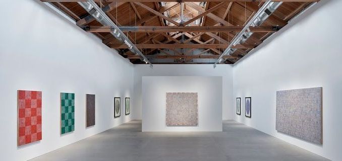 A large room with a lot of paintings on the walls.