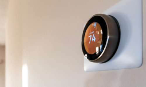 A close up of a thermostat on a wall.